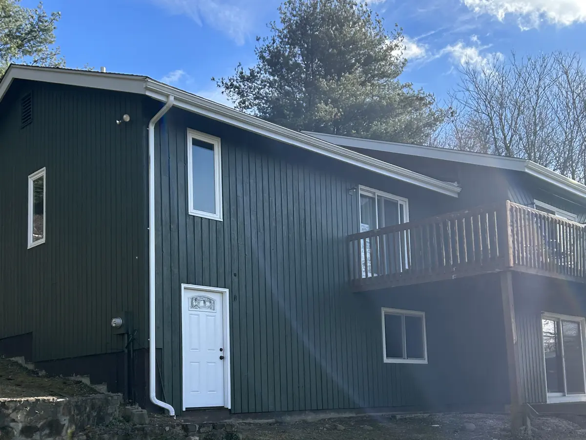 Exterior repaint in deep green with fresh white trim on a Central Connecticut home