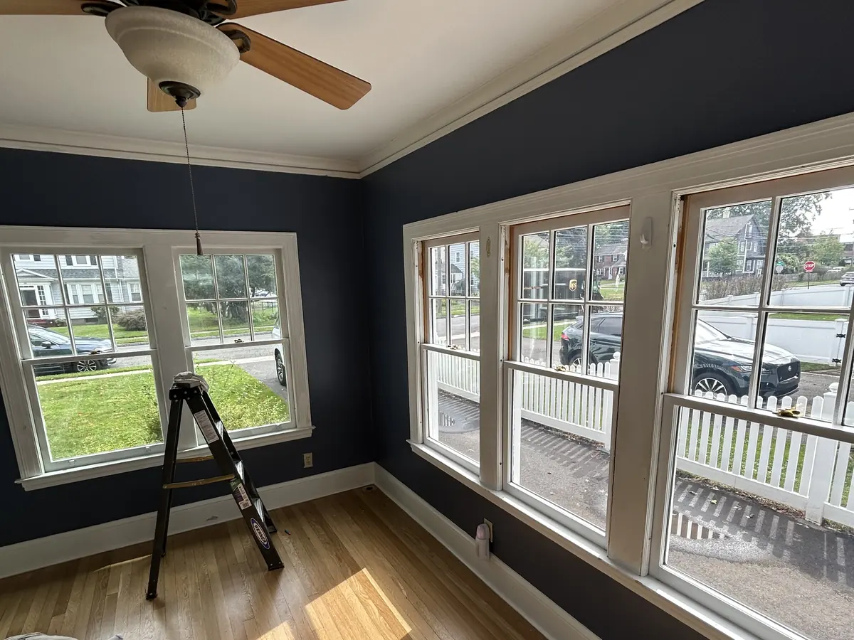 Interior room painted deep navy with white trim and crown molding in Central Connecticut